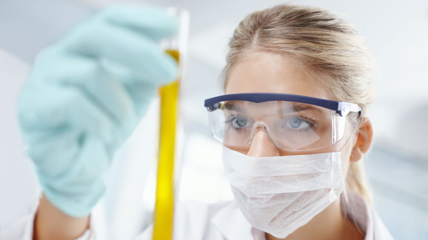 Scientist examining a sample in a lab for accurate mycotoxin testing.